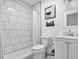 Modern bathroom featuring subway tile shower, updated vanity, and contemporary fixtures at 2211 Englewood Rd, Englewood, FL 34223