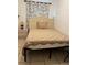 Bedroom with a twin bed featuring patterned bedding, a nightstand, and tile flooring at 2211 Englewood Rd, Englewood, FL 34223