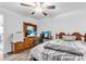 Bright bedroom showcasing wood furniture, striped bedding, ceiling fan and an entertainment center at 2211 Englewood Rd, Englewood, FL 34223