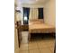 A bedroom with neutral walls, a twin bed with a pink comforter, and tile flooring at 2211 Englewood Rd, Englewood, FL 34223