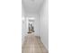 Well-lit hallway showcasing a clean design with tiled floors, and access to multiple rooms in the home at 2211 Englewood Rd, Englewood, FL 34223