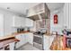 Modern kitchen featuring butcher block countertops, stainless steel appliances, and ample cabinet space at 2211 Englewood Rd, Englewood, FL 34223