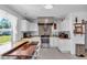 Well-lit kitchen boasting butcher block counters, stainless steel appliances, a brick backsplash, and white cabinets at 2211 Englewood Rd, Englewood, FL 34223