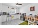 Bright kitchen featuring white cabinets, stainless steel appliances, and an adjacent dining area at 2211 Englewood Rd, Englewood, FL 34223