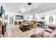 Open-concept living area with tile floors, neutral decor, and a view into the game room at 2211 Englewood Rd, Englewood, FL 34223