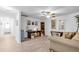 Inviting living area featuring wood-look floors, a desk, and comfortable seating under a ceiling fan at 2211 Englewood Rd, Englewood, FL 34223