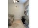 Bright, cozy living space with tiled flooring, a comfortable sofa, and media stand, enhanced by a ceiling fan at 2211 Englewood Rd, Englewood, FL 34223