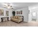 Open living room with neutral walls, light floors, and comfortable seating; features a ceiling fan at 2211 Englewood Rd, Englewood, FL 34223