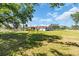 Large grassy yard surrounding a single-story home with a red roof and mature landscaping at 2211 Englewood Rd, Englewood, FL 34223