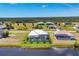 Aerial view showcases a home with a screen-enclosed pool, landscaping, and a waterfront location at 226 W Pine Valley Ln, Rotonda West, FL 33947