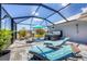 Backyard features lounge chairs, and a hot tub surrounded by serene landscaping with a screened enclosure at 226 W Pine Valley Ln, Rotonda West, FL 33947