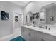 Elegant bathroom featuring double sinks, marble countertops, stylish fixtures, and modern decor at 226 W Pine Valley Ln, Rotonda West, FL 33947