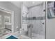 Modern bathroom featuring a glass-enclosed shower with marble tile and a glimpse into the bedroom at 226 W Pine Valley Ln, Rotonda West, FL 33947