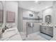 Bright bathroom with double vanity, large mirror, and glass-enclosed shower with custom tile accents at 226 W Pine Valley Ln, Rotonda West, FL 33947