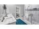 Bright bathroom showcasing a glass-enclosed shower, dual sinks with marble countertops, and modern fixtures at 226 W Pine Valley Ln, Rotonda West, FL 33947
