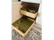 Kitchen cabinet featuring roll out shelves with neatly organized cookware and a patterned rug at 226 W Pine Valley Ln, Rotonda West, FL 33947