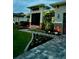 Charming home exterior featuring manicured landscaping, and a paver walkway at 226 W Pine Valley Ln, Rotonda West, FL 33947