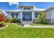 Charming front entrance with stone walkway, well-manicured landscaping, and a welcoming screened-in entryway at 226 W Pine Valley Ln, Rotonda West, FL 33947