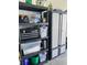 Garage storage shown with black shelving and cabinet with tools, fluids and containers at 226 W Pine Valley Ln, Rotonda West, FL 33947