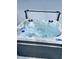 Aspen Spas hot tub with bubbling water and an open cover sits on the patio at 226 W Pine Valley Ln, Rotonda West, FL 33947