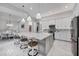 Spacious kitchen with a large island, marble countertops, pendant lights, and modern appliances at 226 W Pine Valley Ln, Rotonda West, FL 33947