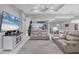 Bright living room featuring reclining sofa set, stylish rug, and television at 226 W Pine Valley Ln, Rotonda West, FL 33947