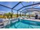 This backyard pool area features a built-in waterfall feature and relaxing views of the property's lake at 226 W Pine Valley Ln, Rotonda West, FL 33947