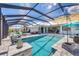Spacious screened-in pool area with ample seating, dining, and a well-maintained pool and hot tub at 226 W Pine Valley Ln, Rotonda West, FL 33947