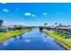 Scenic waterfront view of a canal lined with beautiful homes under a clear blue sky at 226 W Pine Valley Ln, Rotonda West, FL 33947