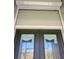Impact windows with a white roll-down hurricane shutter shown closed on home's exterior at 226 W Pine Valley Ln, Rotonda West, FL 33947
