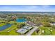 Sweeping aerial view of a golf course community showcasing tennis courts and greens at 2292 Harrier Way, Nokomis, FL 34275