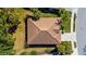 Aerial view of a home's tiled roof surrounded by palms and a well-maintained lawn at 2292 Harrier Way, Nokomis, FL 34275