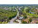 Aerial view of a neighborhood, showcasing manicured green spaces, a private pool, and landscaping at 2292 Harrier Way, Nokomis, FL 34275