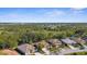 Scenic aerial view of homes with lush landscaping and tile roofs in a well-maintained community at 2292 Harrier Way, Nokomis, FL 34275