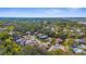 An aerial shows this well-developed community filled with mature trees, manicured lawns, and varied home styles at 2292 Harrier Way, Nokomis, FL 34275