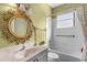 Bathroom with an ornate mirror, vanity, and shower-tub combination with decorative shower curtain at 2292 Harrier Way, Nokomis, FL 34275
