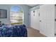 Bedroom featuring a large window, closet and blue blanket on the bed at 2292 Harrier Way, Nokomis, FL 34275