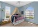 Bright bedroom with a daybed, whimsical decor, and plenty of natural light from the windows at 2292 Harrier Way, Nokomis, FL 34275