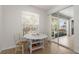 Cozy breakfast nook features a round table and sliding glass doors leading to the lanai at 2292 Harrier Way, Nokomis, FL 34275