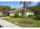 A well-maintained single Gathering home showcasing mature palm trees and meticulously manicured shrubbery at 2292 Harrier Way, Nokomis, FL 34275