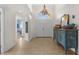 Welcoming foyer with double doors, a decorative chandelier, and a stylish accent cabinet at 2292 Harrier Way, Nokomis, FL 34275