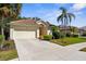 Inviting single-Gathering home with a barrel tile roof, two-car garage, and well-maintained landscaping at 2292 Harrier Way, Nokomis, FL 34275