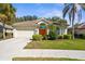 Charming single-story home with lush landscaping, a barrel tile roof, and a two-car garage at 2292 Harrier Way, Nokomis, FL 34275