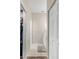 Hallway featuring tile floor, coat closet and utility closet with vanity at the end at 2292 Harrier Way, Nokomis, FL 34275
