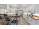 Bright kitchen features white cabinets, stainless steel appliances, and a breakfast bar with seating at 2292 Harrier Way, Nokomis, FL 34275