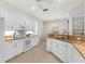 A modern kitchen boasting white cabinetry, granite countertops, and stainless steel appliances at 2292 Harrier Way, Nokomis, FL 34275