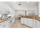 Bright kitchen with white cabinets, granite countertops, stainless steel appliances, and a breakfast nook at 2292 Harrier Way, Nokomis, FL 34275