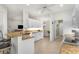 Well-lit kitchen featuring white cabinetry, a breakfast bar, and an open layout at 2292 Harrier Way, Nokomis, FL 34275