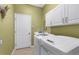 Well-equipped laundry room with modern washer and dryer at 2292 Harrier Way, Nokomis, FL 34275