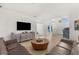 Open-concept living room featuring neutral tones, tile floors, and elegant furnishings at 2292 Harrier Way, Nokomis, FL 34275